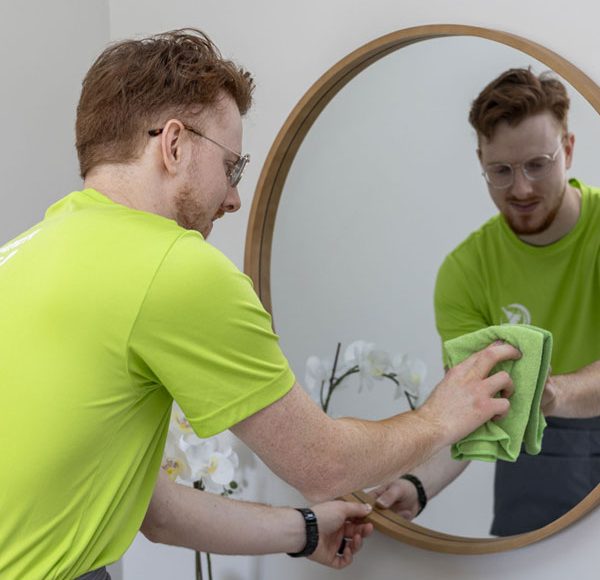a men cleaning a mirror